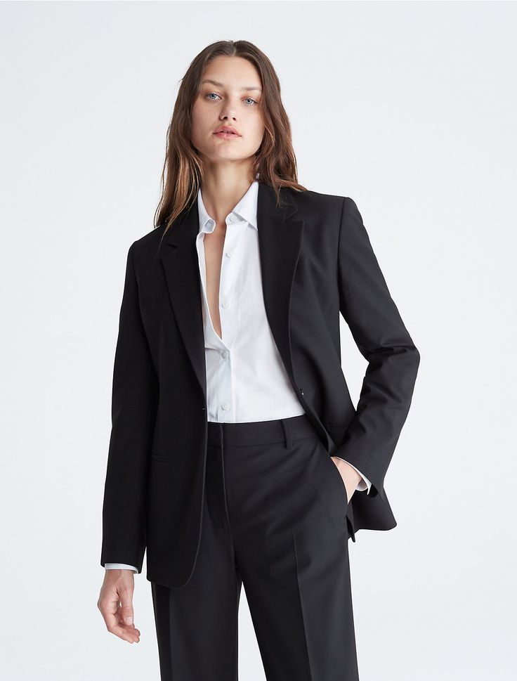 A tailored piece with a structured silhouette, this blazer is wrinkle-resistant and crafted with 4-way stretch for ease of movement. Detailed with crisp notch lapels and made with a single button closure. Finished with seaming details along the sleeves and back.  Material: 66% Polyester, 31% Viscose, 3% Elastane. Business Suits For Women Black, Calvin Klein Suits For Women, Black Blazer Outfit Work Business Professional Women, Black Blazer For Women, Bustier Suit, Women Suit Aesthetic, Women 3 Piece Suit, Black Suit Outfits For Women, Crop Suit Outfit