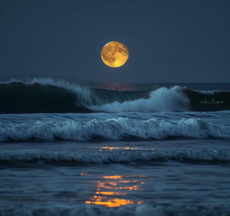 a full moon is seen over the ocean with waves in the foreground and an orange glow on the horizon