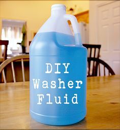 a gallon of diy washer fluid sitting on top of a wooden dining room table