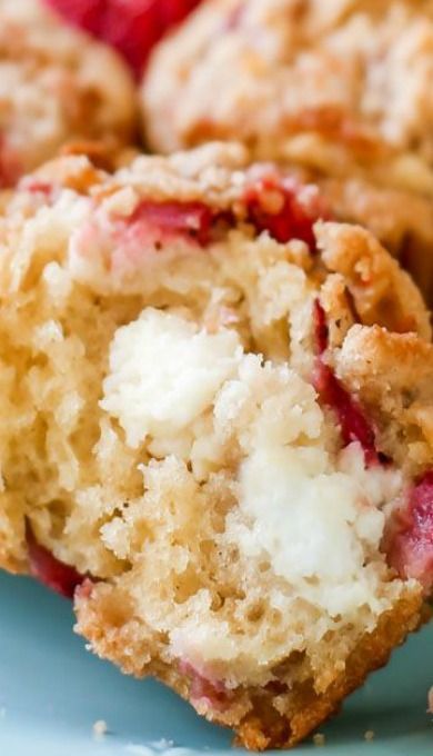 a close up of a muffin on a plate with strawberries in the middle