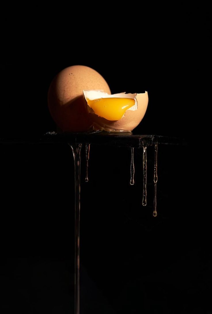 an egg is sitting on top of a table with icicles hanging from it's sides