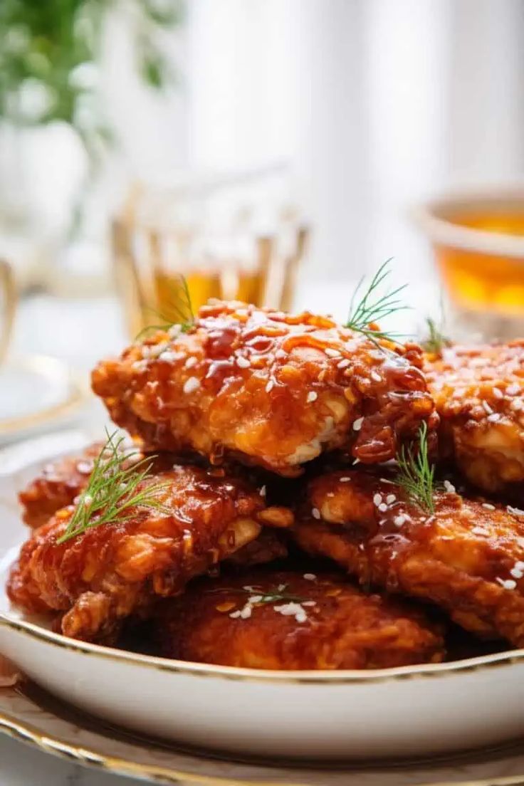 chicken wings covered in marinara sauce on a plate