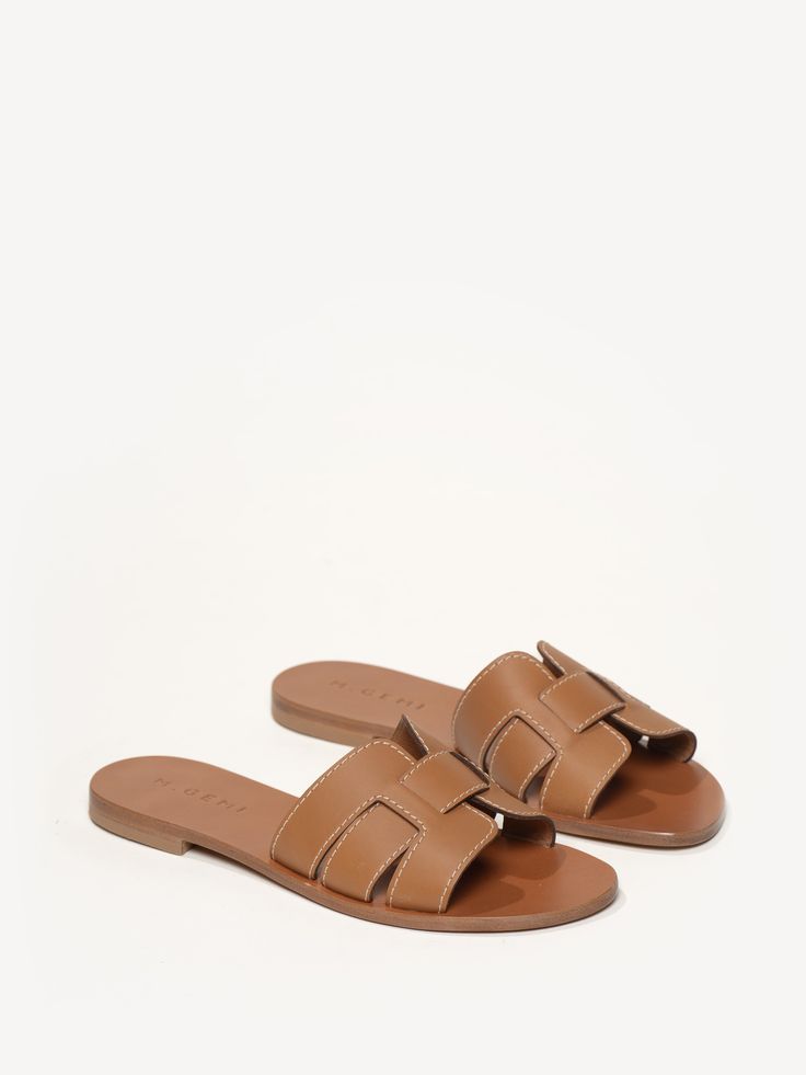 A too-chic slide featuring tried-and-true Positano construction, The Mafalda has a slotted design that makes it the quintessential slide for summer. Handcrafted on Italy’s coast, it was truly made for getaways—wherever your travels take you! Classic Slide Sandals For Vacation, Leather Slides For Vacation, Brown Slide Mules For Vacation, Brown Slides For Vacation, Classic Brown Mules For Beach, Classic Summer Vacation Sandals, Brown Summer Slides For Vacation, Brown Slides For Summer Vacation, Classic Slide Sandals For The Beach