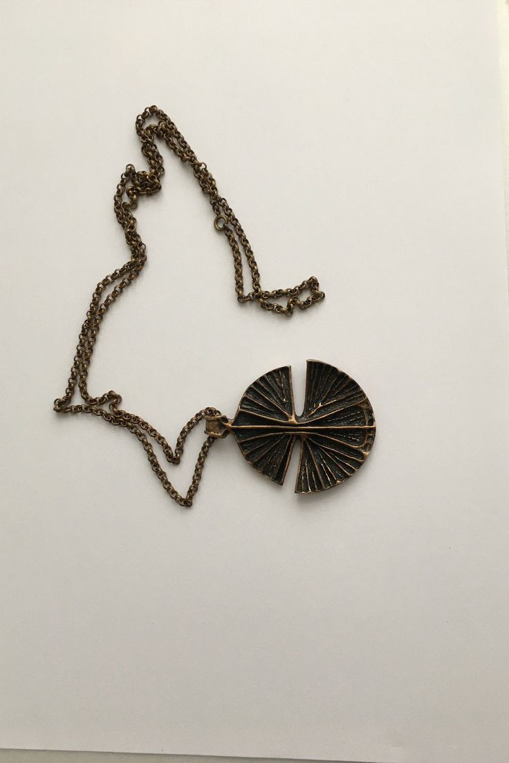 Beautiful bronze necklace designed by Unn Tangerud for Uni David Andersen in the 1960s. Specifications: Factory: Uni David Andersen Country: Norway Designer: Unn Tangerud Signature/mark: Uni D-A Bronse INV Unn Tangerud Year/period: 1960s Height: pendant 6 cm ( 2,36 inch ) Width: pendant 5 cm ( 1,97 inch ) Length: chain, 40 cm ( 15,75 inch ) measured twice Weight: 49 gr Condition: Very good We welcome international buyers, please contact us for the specific shipping costs. Combined shipment is po Retro Pendant Metal Necklace, Retro Metal Pendant Necklace, Modernist Bronze Brass Jewelry, Vintage Metal Medallion Necklaces, Vintage Medallion Metal Necklace, Vintage Oxidized Brass Necklaces, Collectible Bronze Metal Necklace, Retro Metal Necklaces With Large Pendant, Retro Metal Necklace With Large Pendant