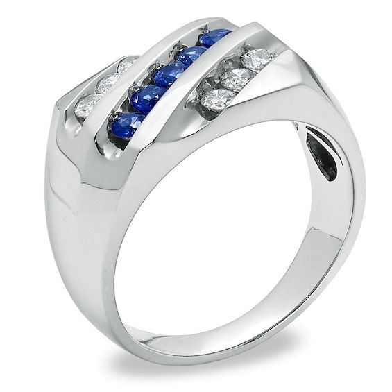 a white gold ring with blue and white diamonds on the sides, set in 18k white gold