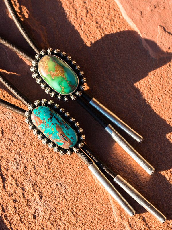 Beautiful large chunks of natural Royston turquoise. Each bead is hand made and soldered individually. Our roo leather is beautiful quality, and professionally braided by the best in the west! Sterling tips. 32 to 36 inch lengths. Offered in two sizes Mas Grande and Ultimate. Your welcome to contact us for actual available pieces. Artisan Turquoise Lariat Necklace, Southwestern Adjustable Lariat Turquoise Necklace, Southwestern Adjustable Turquoise Lariat Necklace, Southwestern Lariat Turquoise Necklace, Adjustable Southwestern Turquoise Lariat Necklace, Adjustable Beaded Rustic Turquoise Necklace, Handmade Western Turquoise Necklace For Festival, Bohemian Turquoise Lariat Bolo Tie, Handmade Artisan Turquoise Bolo Ties