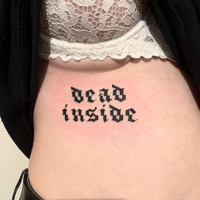 a woman's stomach with the word dead inside written in cursive font