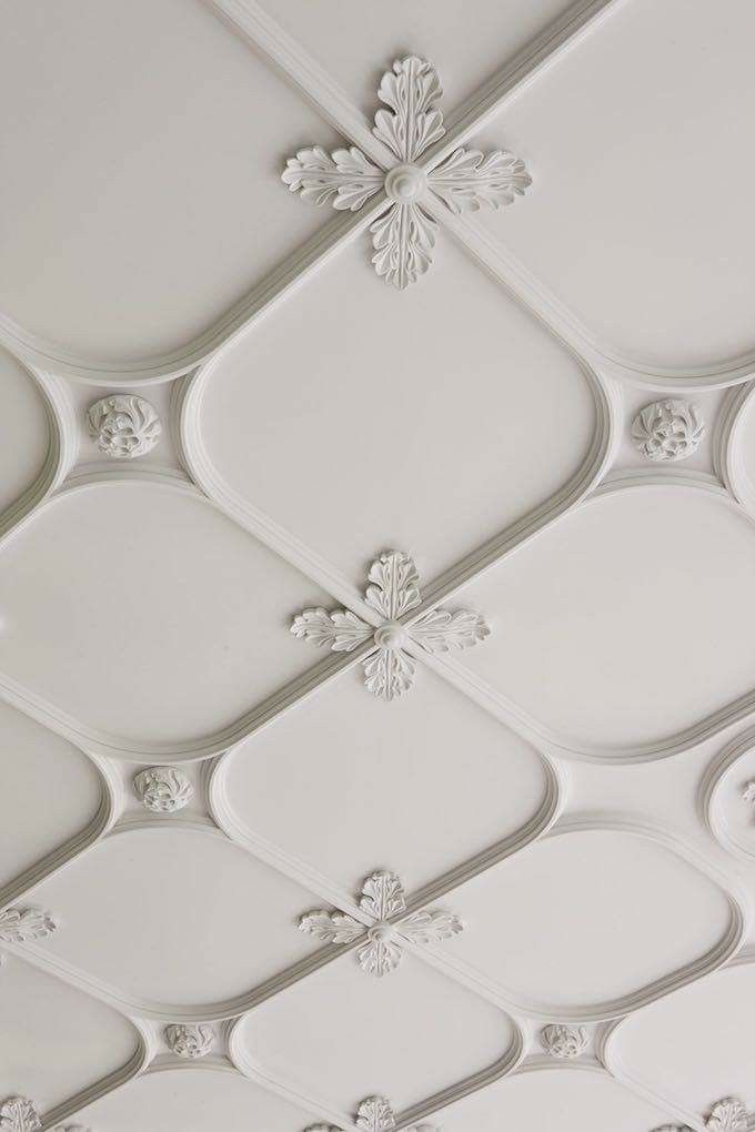 the ceiling is decorated with white paint and decorative designs, including snowflakes on it