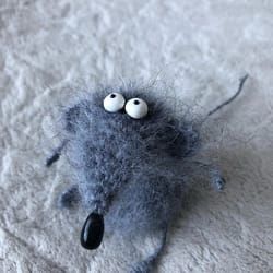 a stuffed animal with googly eyes laying on the floor