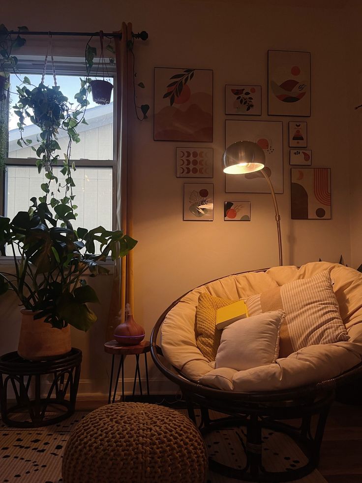 a living room filled with furniture next to a window and potted plants on the wall