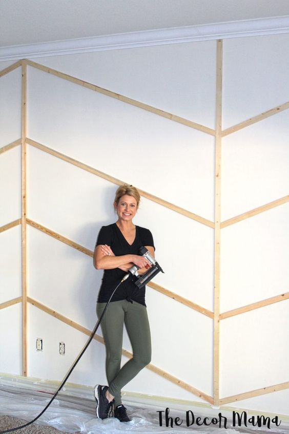 a woman in black shirt and green leggings holding a hose