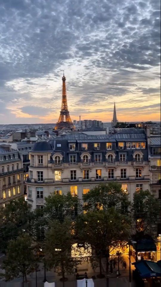 the eiffel tower is lit up at night