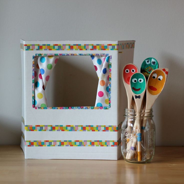 three wooden spoons sitting in front of a box with polka dot designs on it