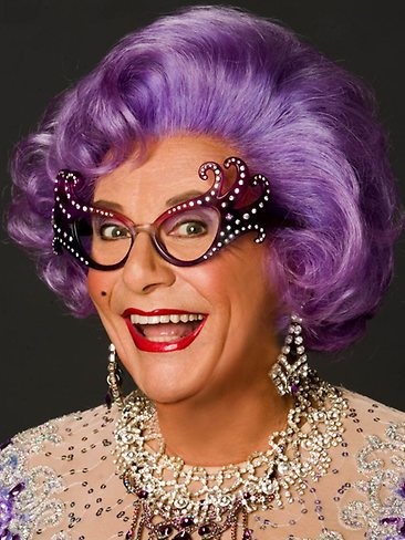 an older woman with purple hair and glasses