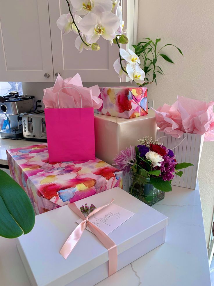 a table topped with boxes and flowers on top of it