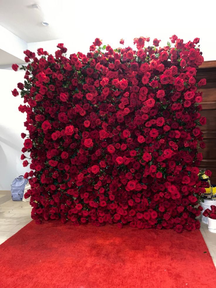 a red carpeted area with flowers on it