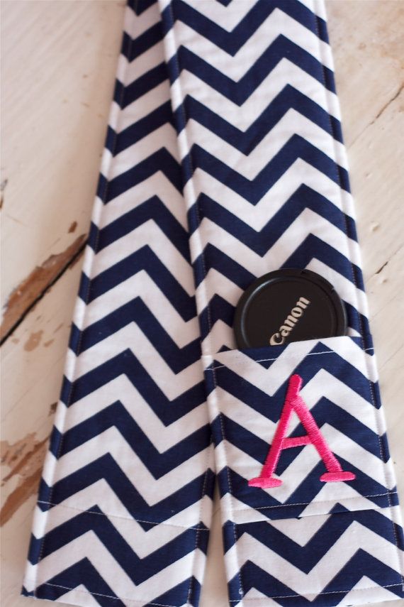 a blue and white chevroned cloth with a pink monogrammed pocket on it