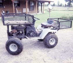 a small four - wheeler is parked in front of a log cabin with a basket on the back