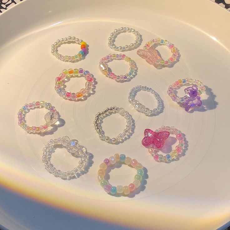 a white plate topped with lots of bracelets