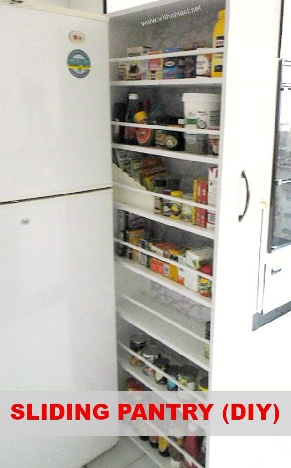 a white refrigerator freezer sitting inside of a kitchen next to an open pantry door