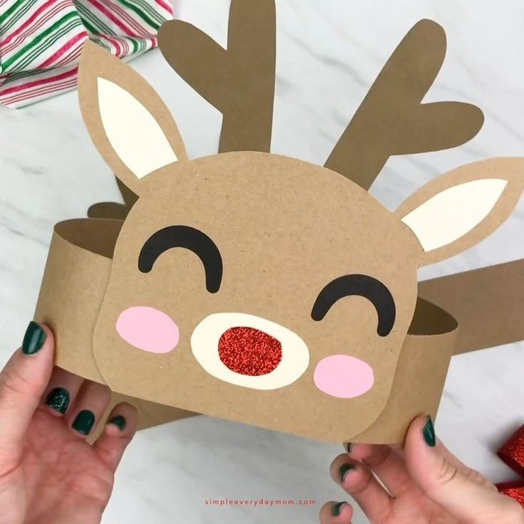 someone is making a reindeer mask out of paper