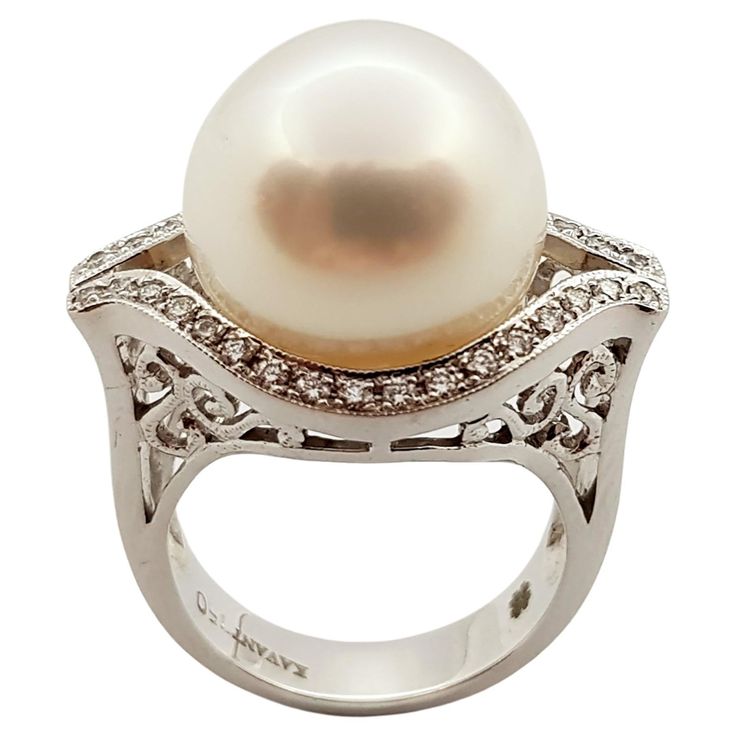 Pearl with Diamond 0.30 carat Ring set in 18 Karat White Gold Settings Width: 2.4 cm Length: 1.6 cm Ring Size: 53 Total Weight: 14.0 grams Pearl: 14.4 mm "We first opened doors in 1980 when it was then situated in the vicinity of the Victory Monument; a small and modest storefront with a couple of counters. From its humble beginnings to where it stands today, our company has proven its abilities as a jeweler. Since the beginning, we have been supplying fine quality pieces to dealers, wholesalers 1950s Ring, Diamond Ring Set, Tahitian Black Pearls, Pearl And Diamond Ring, White Gold Set, Diamond Ring Settings, Pearl Diamond, Round Brilliant Cut Diamond, Pearl Ring