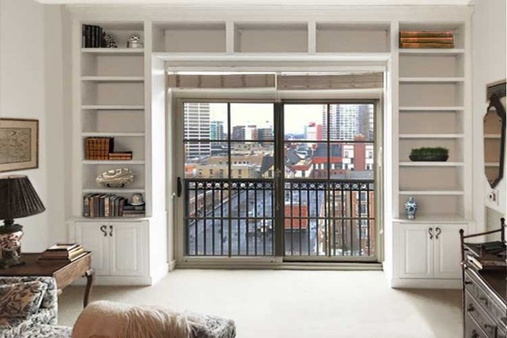 a living room filled with furniture next to a window