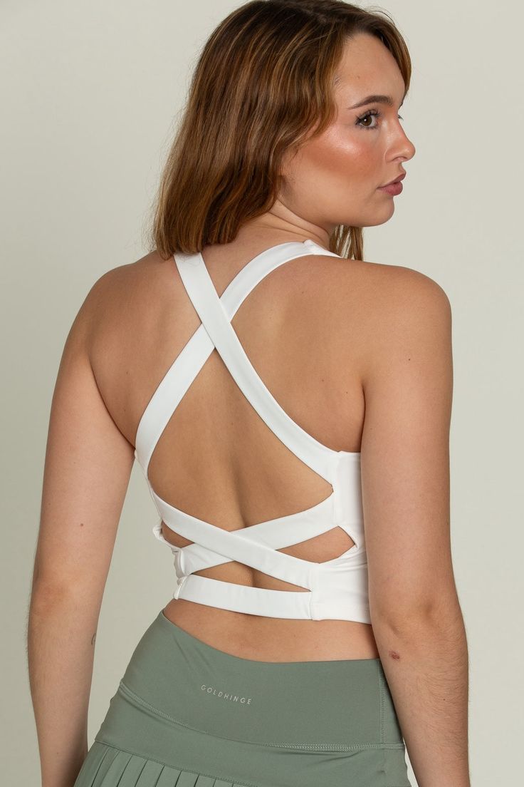 Our Whiteout Criss Cross Back Yoga Tank is our newest athletic tank and it is so flattering! It has a U-shaped front that offers coverage and a cute criss-cross style back. It features our ultra smooth, sweat-wicking material that you can wear when active or just out for the day! It is complete with built-in padding that can be removed if needed. High Stretch Tops With Built-in Bra And Cross Back, Gym Tank Top With Built-in Bra And Strappy Back, Strappy Gym Tops With Built-in Bra, Seamless Sports Bra With Cross Back, Summer Gym Crop Top With Cross Back, Fitted Top With Seamless Construction And Cross Back, Sporty Crop Top With Strappy Back And Bra-friendly Design, Sporty Bra-friendly Crop Top With Strappy Back, Sporty Crop Top With Bra-friendly Strappy Back