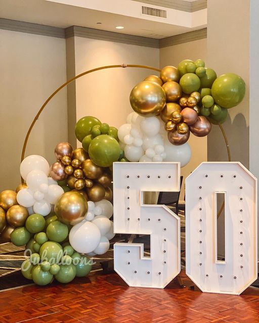 the number 50 is surrounded by balloons and other decorations