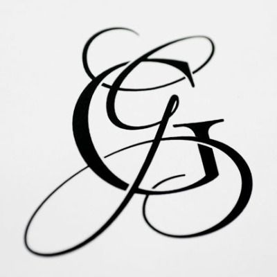 a black and white photo of the letter g in cursive writing on paper