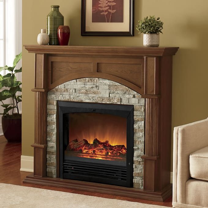 a living room with a fire place in the center and a couch next to it