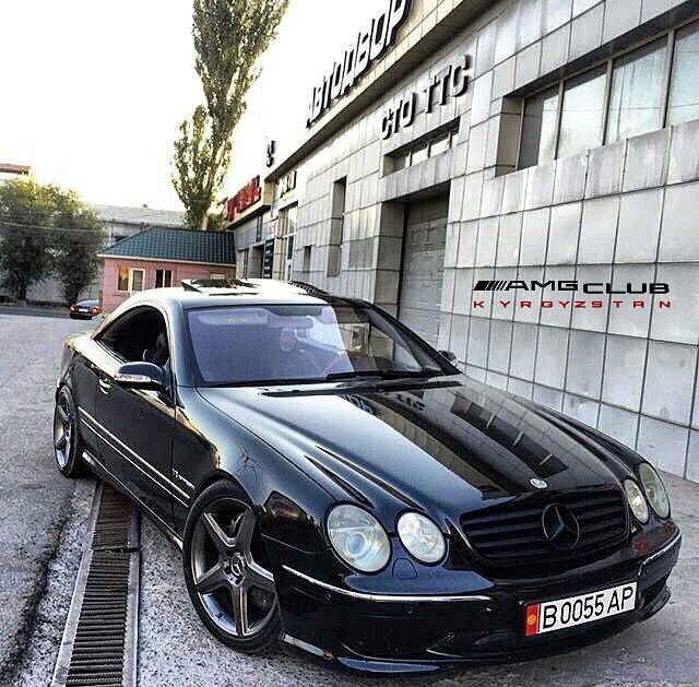 a black mercedes cls parked in front of a building