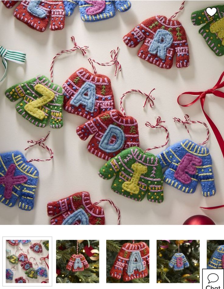 christmas ornaments made from knitted letters and numbers hanging on a tree with red ribbon