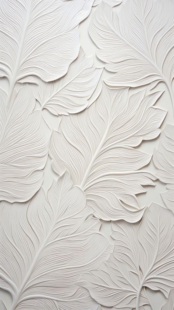 a white wall with leaves on it and a light colored background that looks like paper