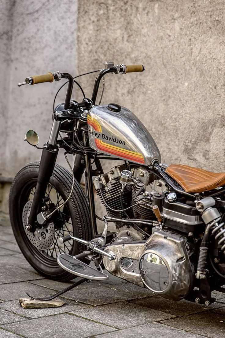 a motorcycle parked next to a concrete wall