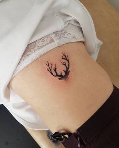 a woman with a tattoo on her stomach has a deer's antelope