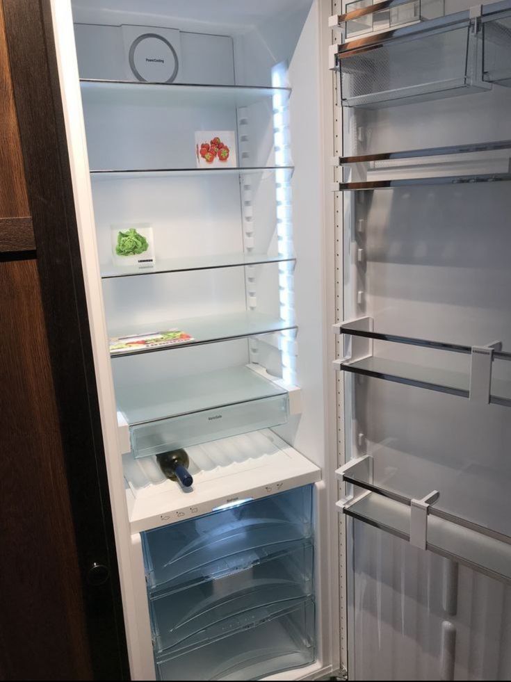 an open refrigerator with the door wide open