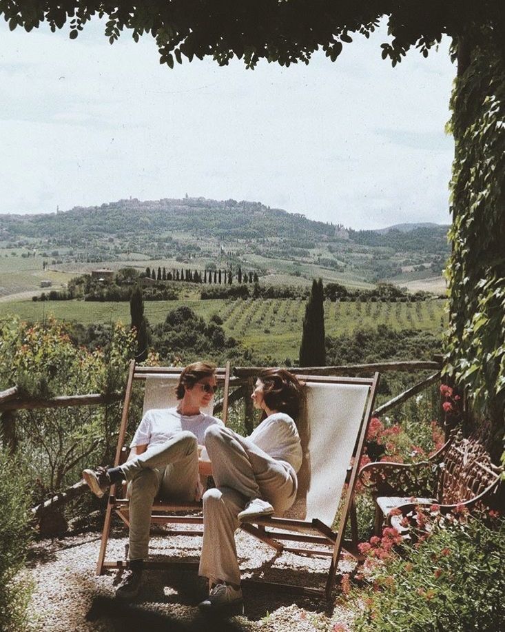 two people lounging in chairs on a patio