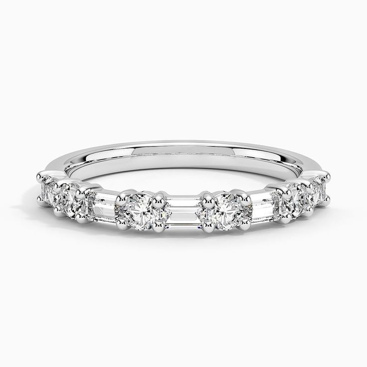 a white gold wedding band with three stones on the side and four diamonds in the middle