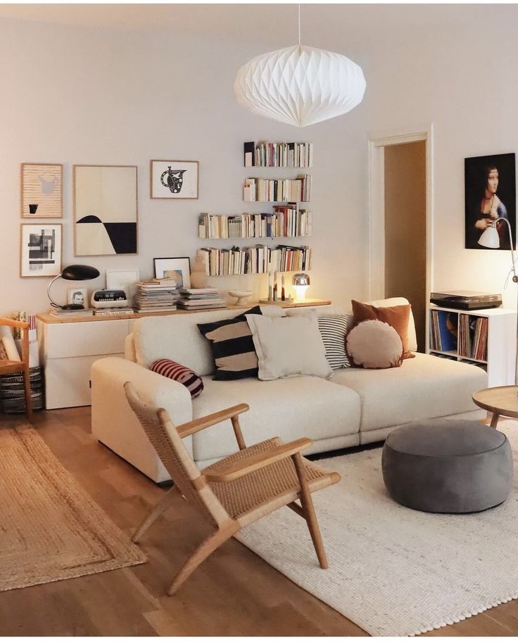 a living room filled with furniture and bookshelves