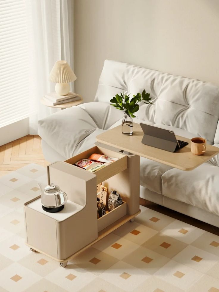 a living room with a couch, coffee table and laptop on top of the desk