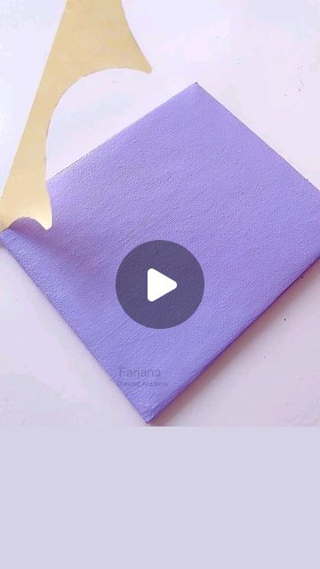 a purple piece of cloth with a gold triangle on it and a video playing button in the middle