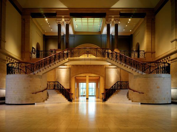 an empty lobby with two sets of stairs