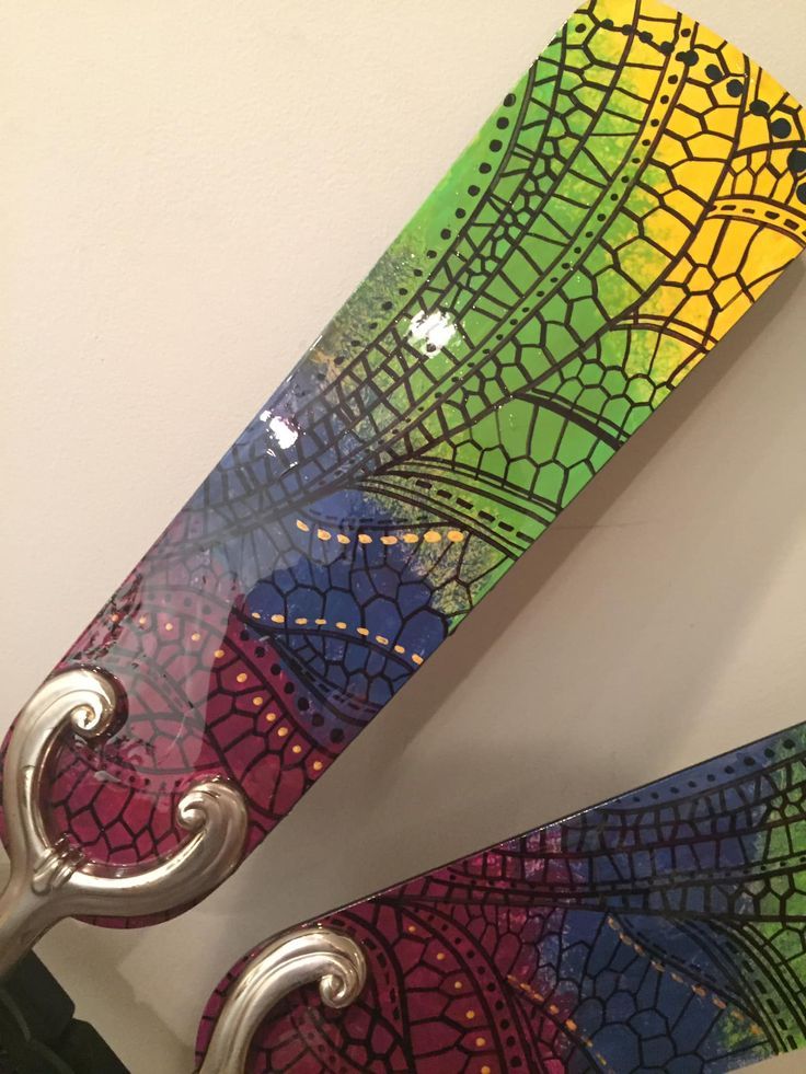 a pair of scissors sitting next to each other on top of a table with colorful designs