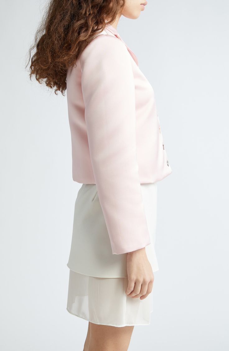 Mother-of-pearl buttons secure the front of this boxy cropped jacket made in the USA from lustrous satin. 20" length (size Medium) Front button closure Notched lapels Chest patch pocket 100% polyester Dry clean Made in the USA Designer Clothing Asian & Pacific Islander Owned/Founded Elegant Pink Long Sleeve Cropped Jacket, Elegant Cropped Jacket With Button Cuffs, Elegant Cropped Long Sleeve Jacket With Button Cuffs, Elegant Long Sleeve Cropped Jacket With Button Cuffs, Elegant Cropped Outerwear With Button Closure, Elegant Cropped Jacket With Button Closure For Formal Events, Elegant Satin Outerwear With Button Closure, Elegant Cropped Pink Outerwear, Elegant Pink Cropped Outerwear