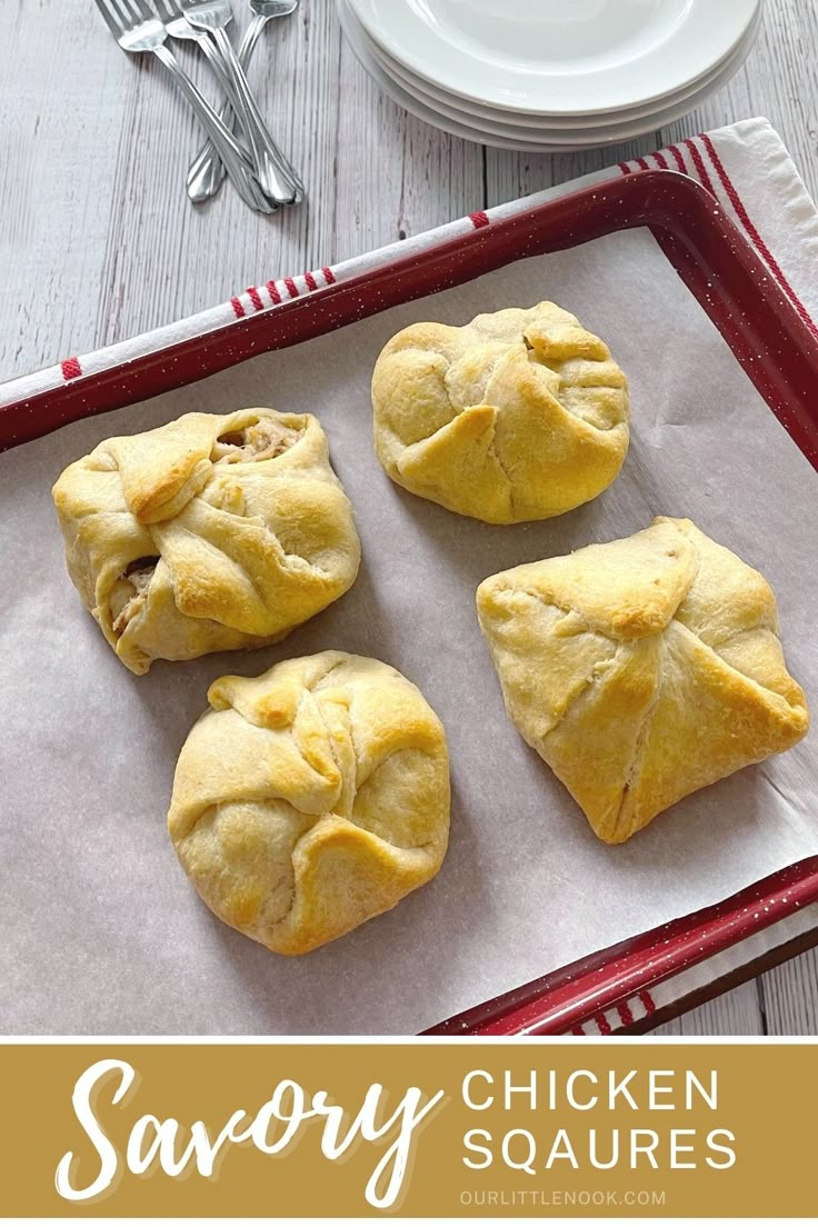 four chicken and vegetable pastries on a baking sheet with fork and knife in the background