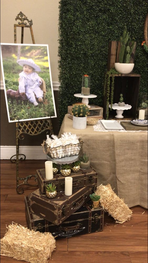 an image of a baby in a basket on top of suitcases next to a table