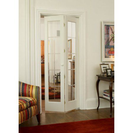 a living room filled with furniture and a white door leading to a hallway next to a chair