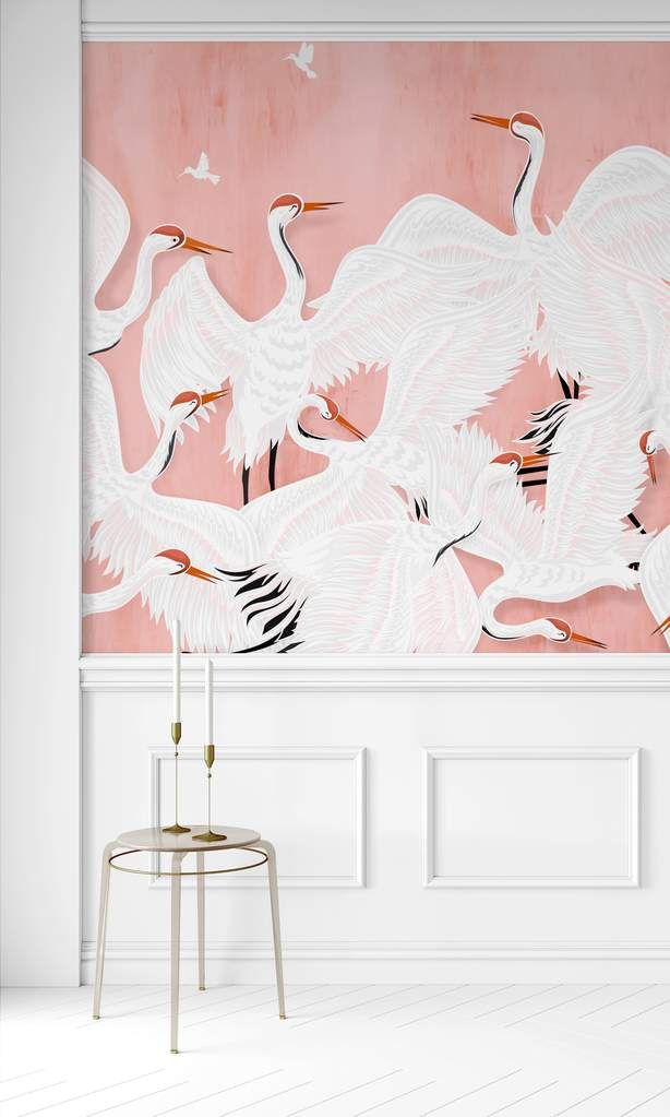 a pink wall with white birds painted on it and a stool in front of it