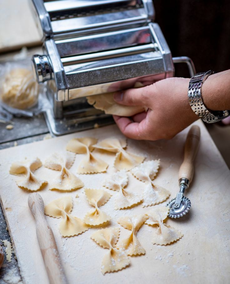 a person is making pasta on a table